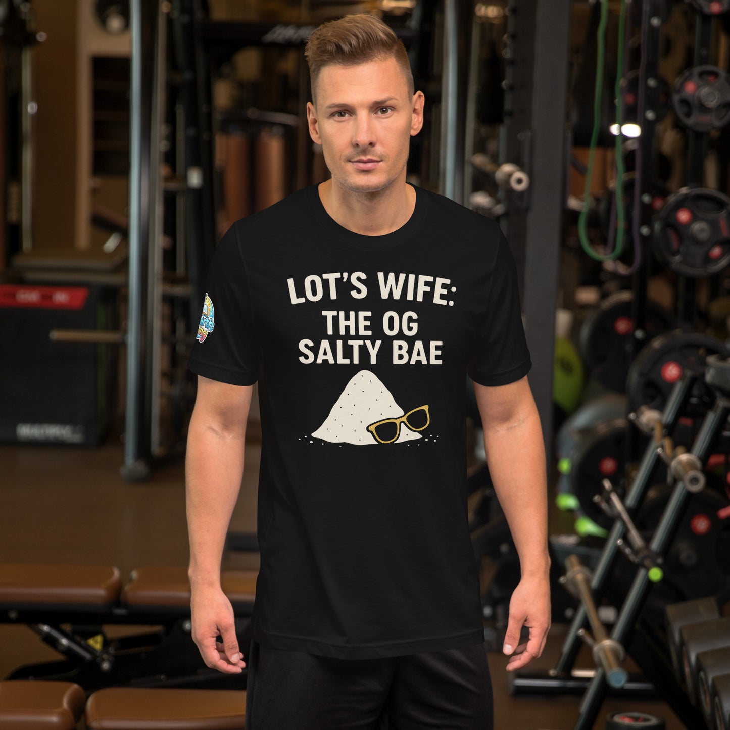 Model wearing a black t-shirt with text and graphics in a gym setting. Lot’s Wife: The OG Salty Bae – funny Christian t-shirt, black, Bible humor design by ReBirth Living