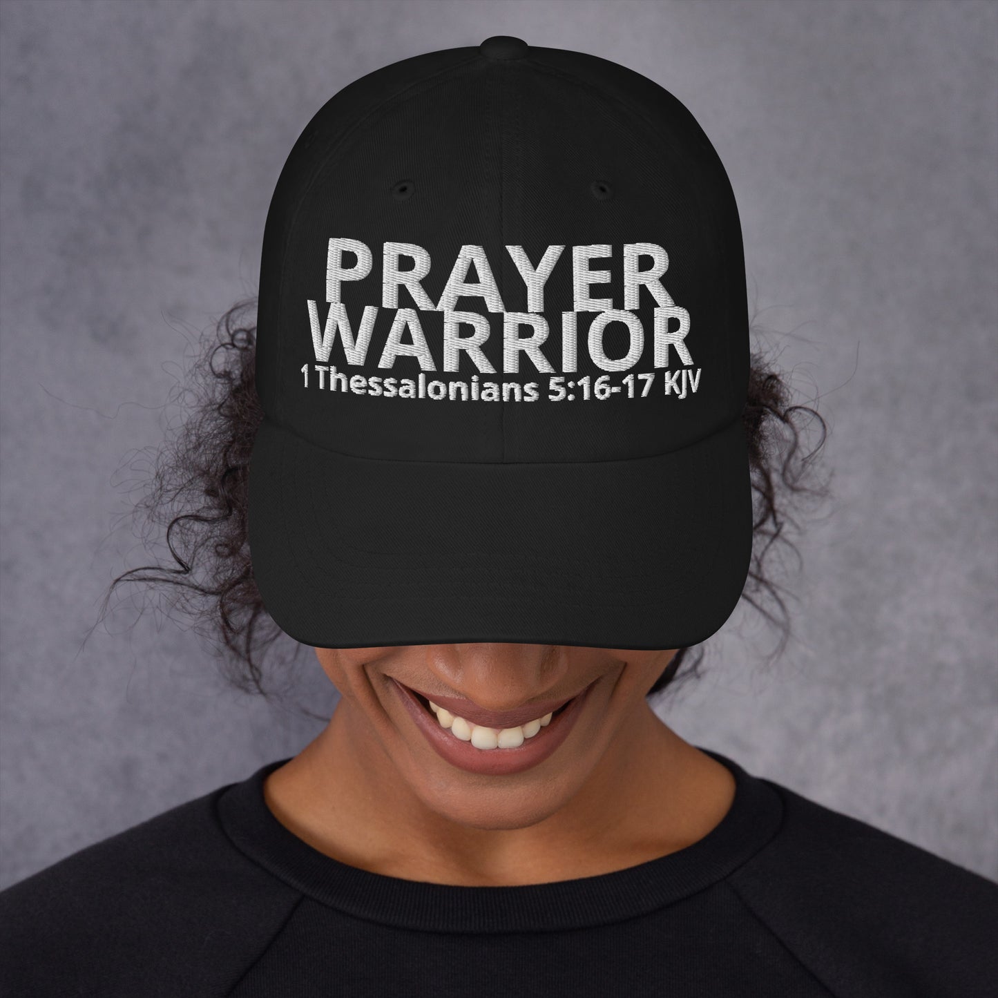 A person wearing a Prayer Warrior black cap – 1 Thessalonians 5:16–17 KJV embroidered Christian hat, adjustable unisex, black, faith-based headwear by ReBirth Living
