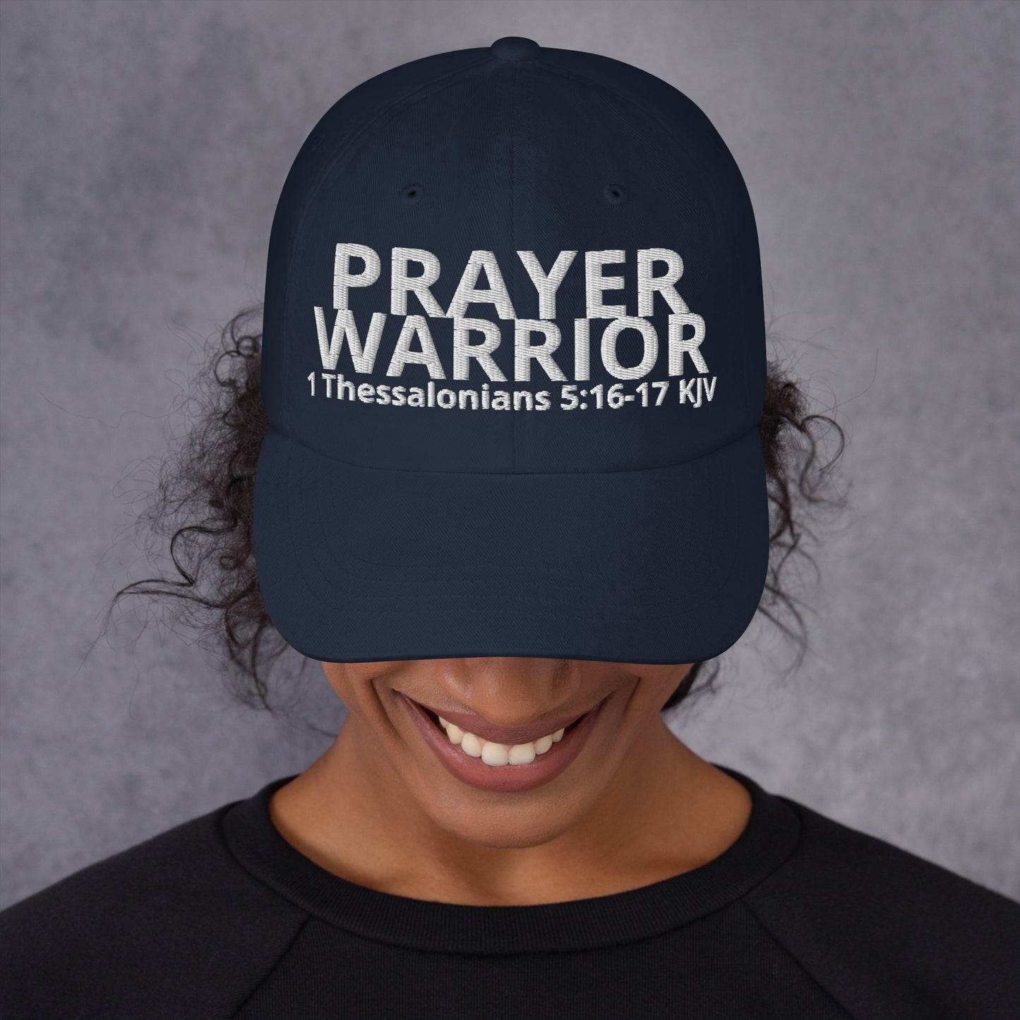 A person wearing a Prayer Warrior black cap – 1 Thessalonians 5:16–17 KJV embroidered Christian hat, adjustable unisex, navy, faith-based headwear by ReBirth Living