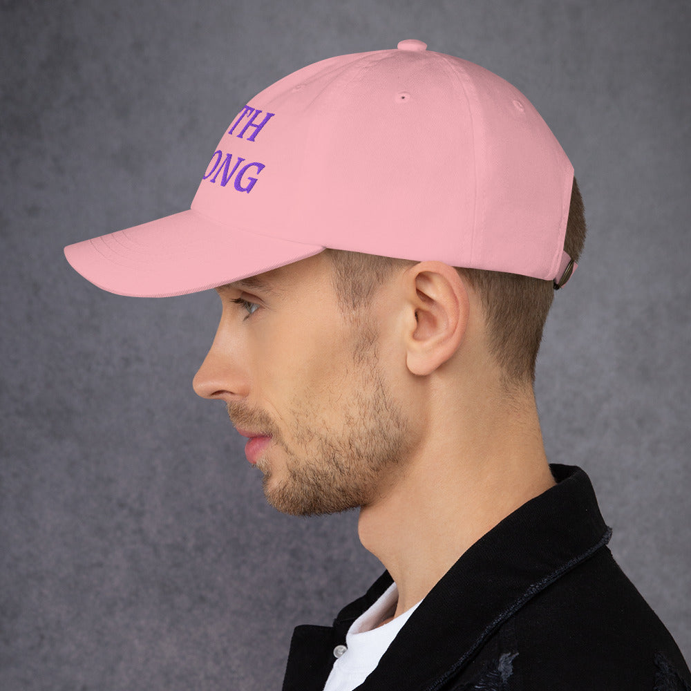 Model is wearing a Faith Strong embroidered hat – bold purple text, pink adjustable unisex cap by ReBirth Living
