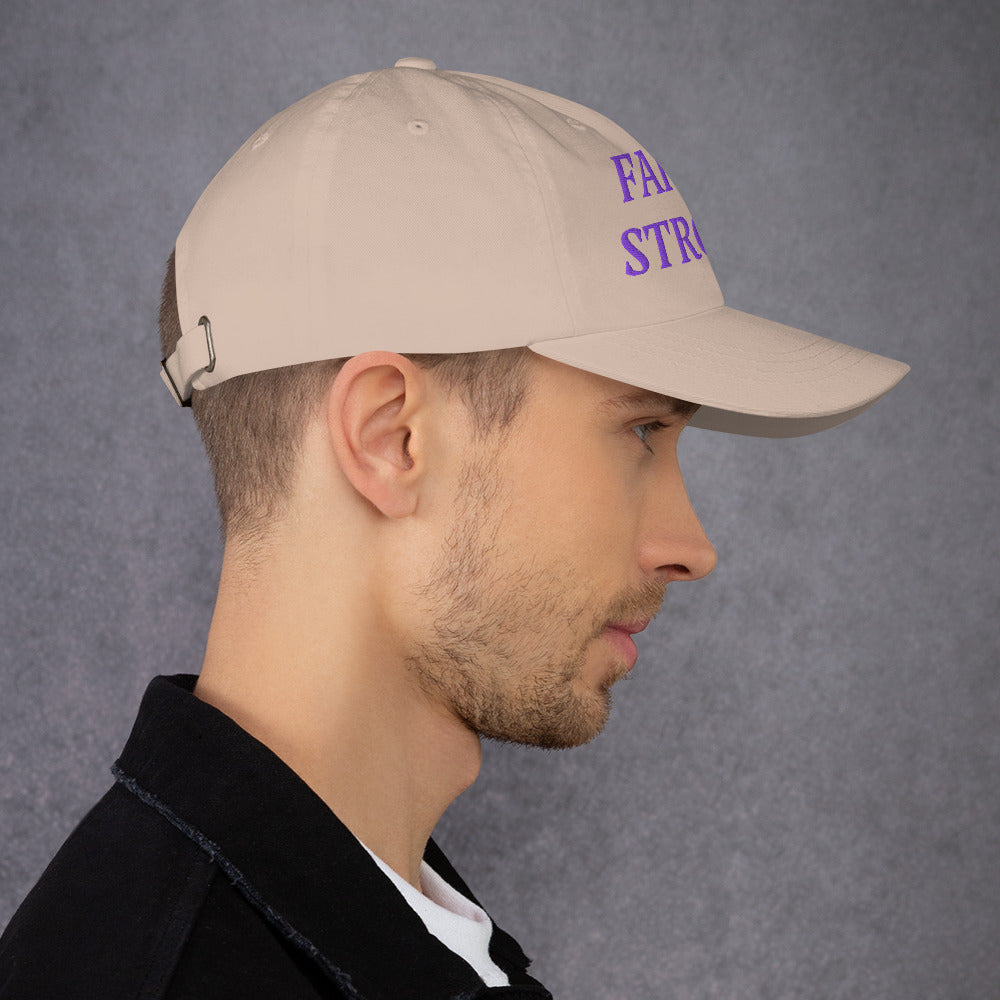 Model is wearing a Faith Strong embroidered hat – bold purple text, stone adjustable unisex cap by ReBirth Living