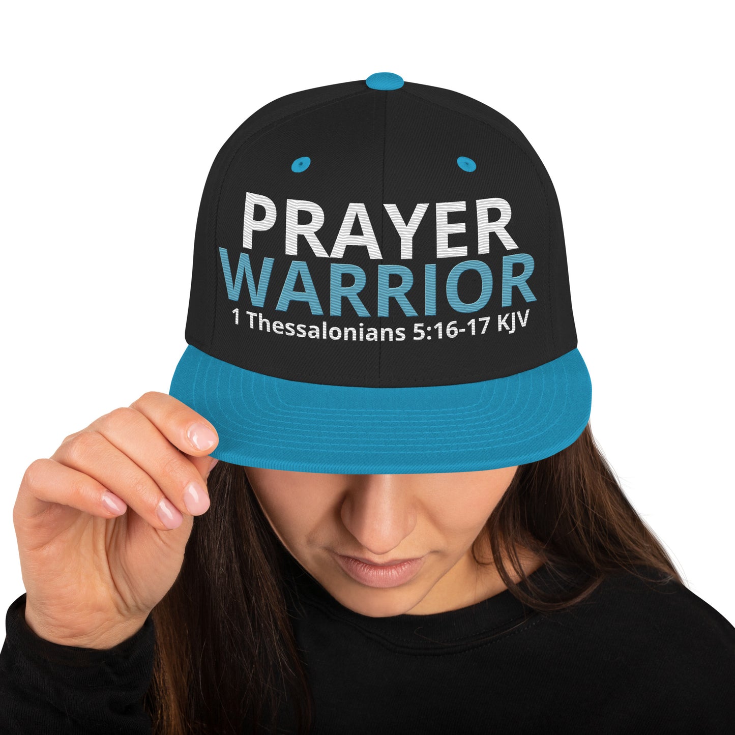 A person is wearing a Prayer Warrior snapback hat – 1 Thessalonians 5:16-17 KJV embroidered Christian cap, adjustable unisex design by ReBirth Living.