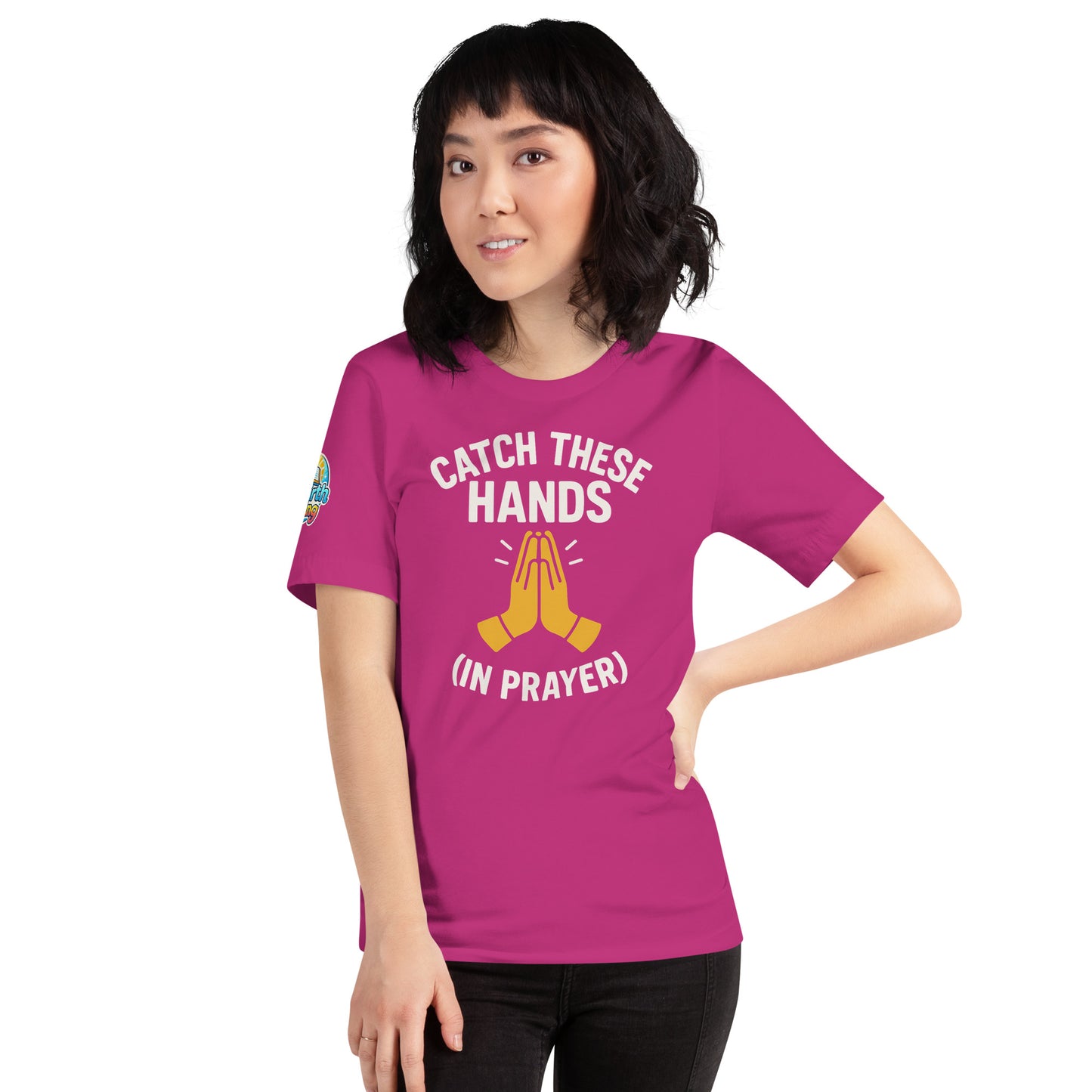 Model wearing “Catch These Hands (In Prayer)” – funny Christian t-shirt, berry, faith-based humor design with golden praying hands by ReBirth Living