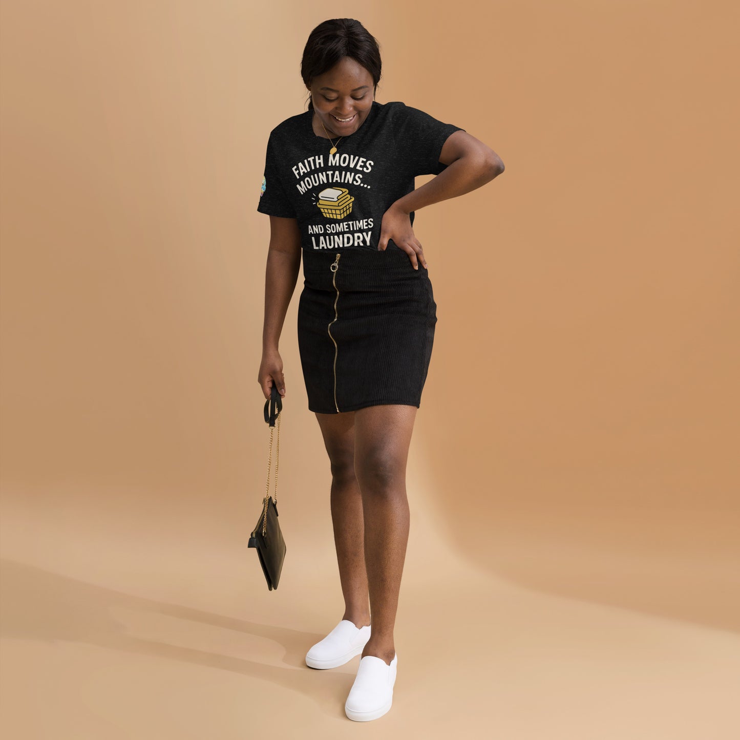 Model showcasing a Faith Moves Mountains… and Sometimes Laundry – funny Christian t-shirt, black heather, faith-based humor design by ReBirth Living