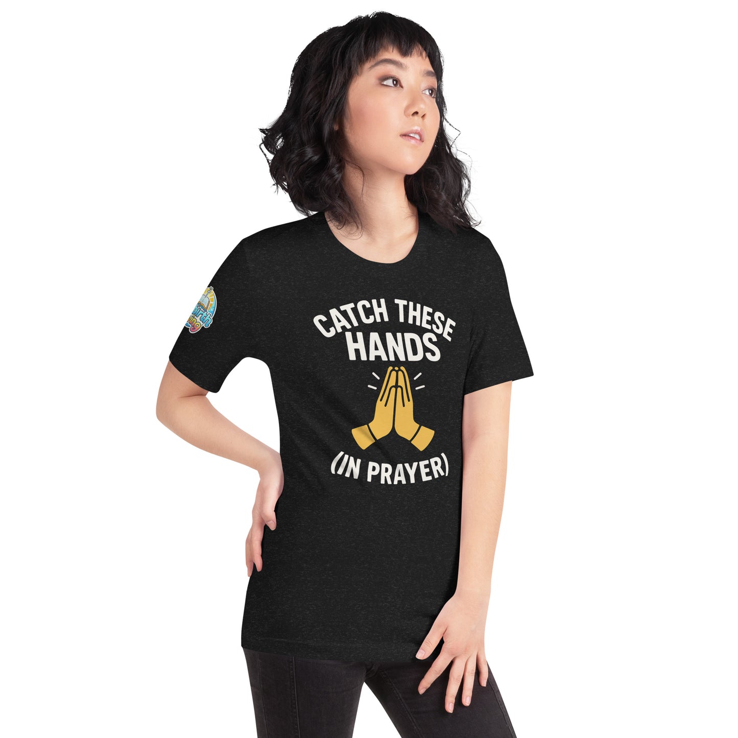 Model wearing “Catch These Hands (In Prayer)” – funny Christian t-shirt, black, faith-based humor design with golden praying hands by ReBirth Living