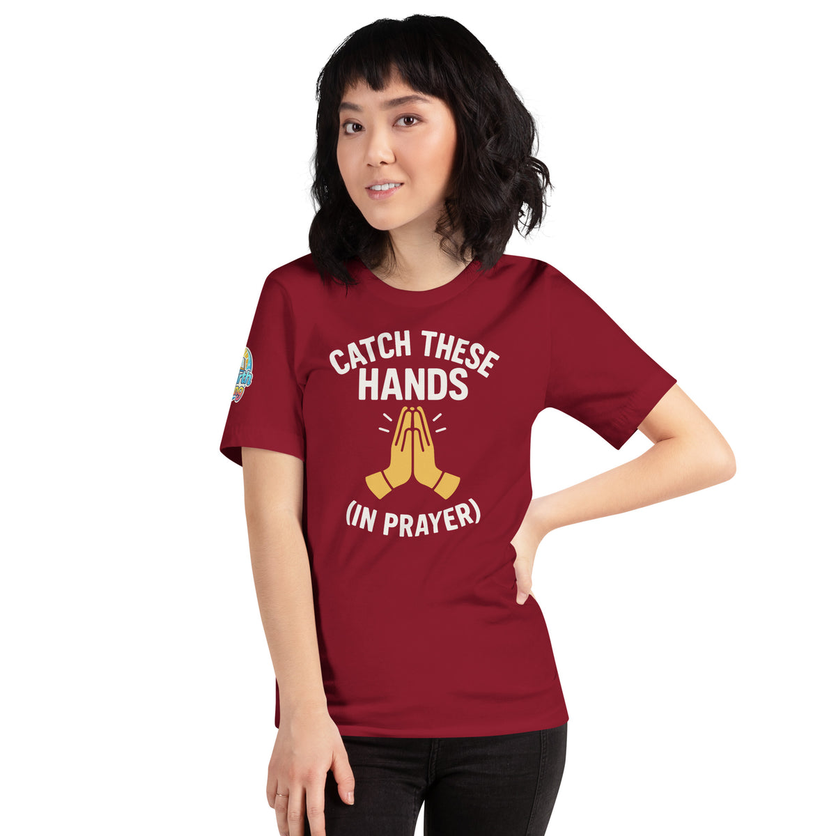 Model wearing “Catch These Hands (In Prayer)” – funny Christian t-shirt, cardinal, faith-based humor design with golden praying hands by ReBirth Living