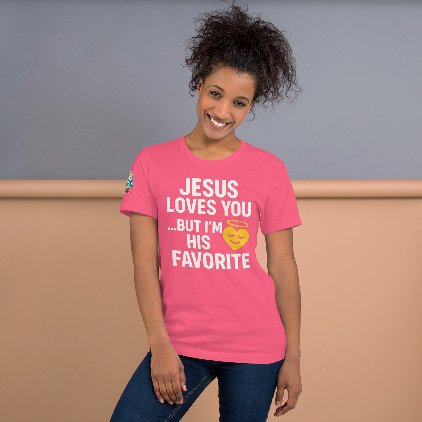 Model wearing “Jesus Loves You… But I’m His Favorite” – funny Christian t-shirt, charity pink, faith humor design with golden smiling heart and halo by ReBirth Living