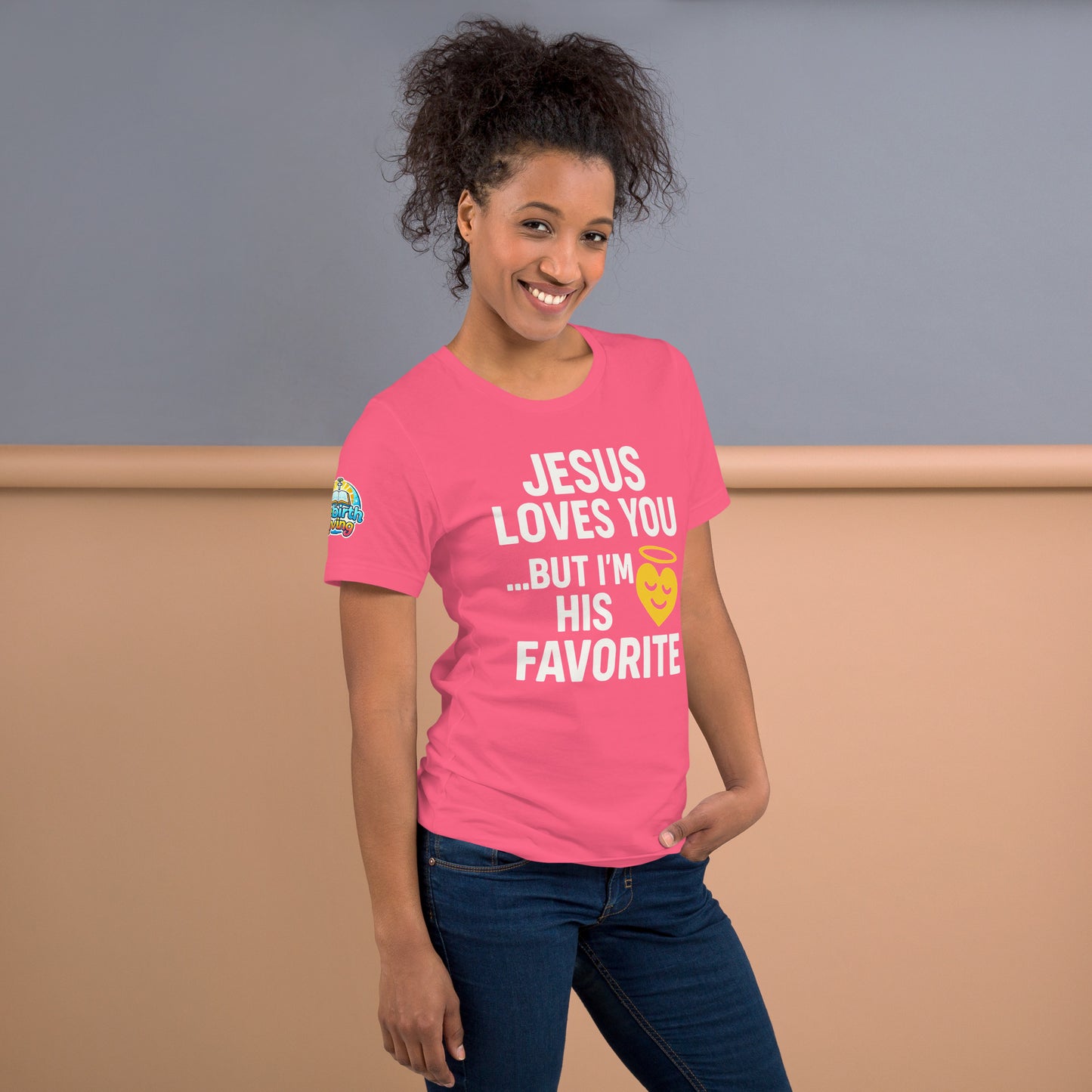 Model wearing “Jesus Loves You… But I’m His Favorite” – funny Christian t-shirt, charity pink, faith humor design with golden smiling heart and halo by ReBirth Living