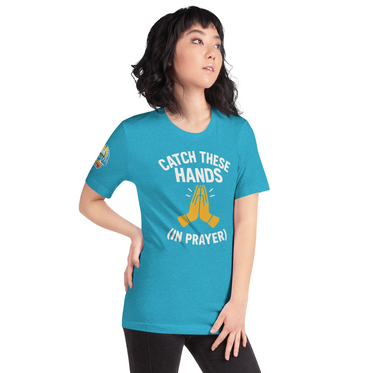 Model wearing “Catch These Hands (In Prayer)” – funny Christian t-shirt, heather aqua, faith-based humor design with golden praying hands by ReBirth Living