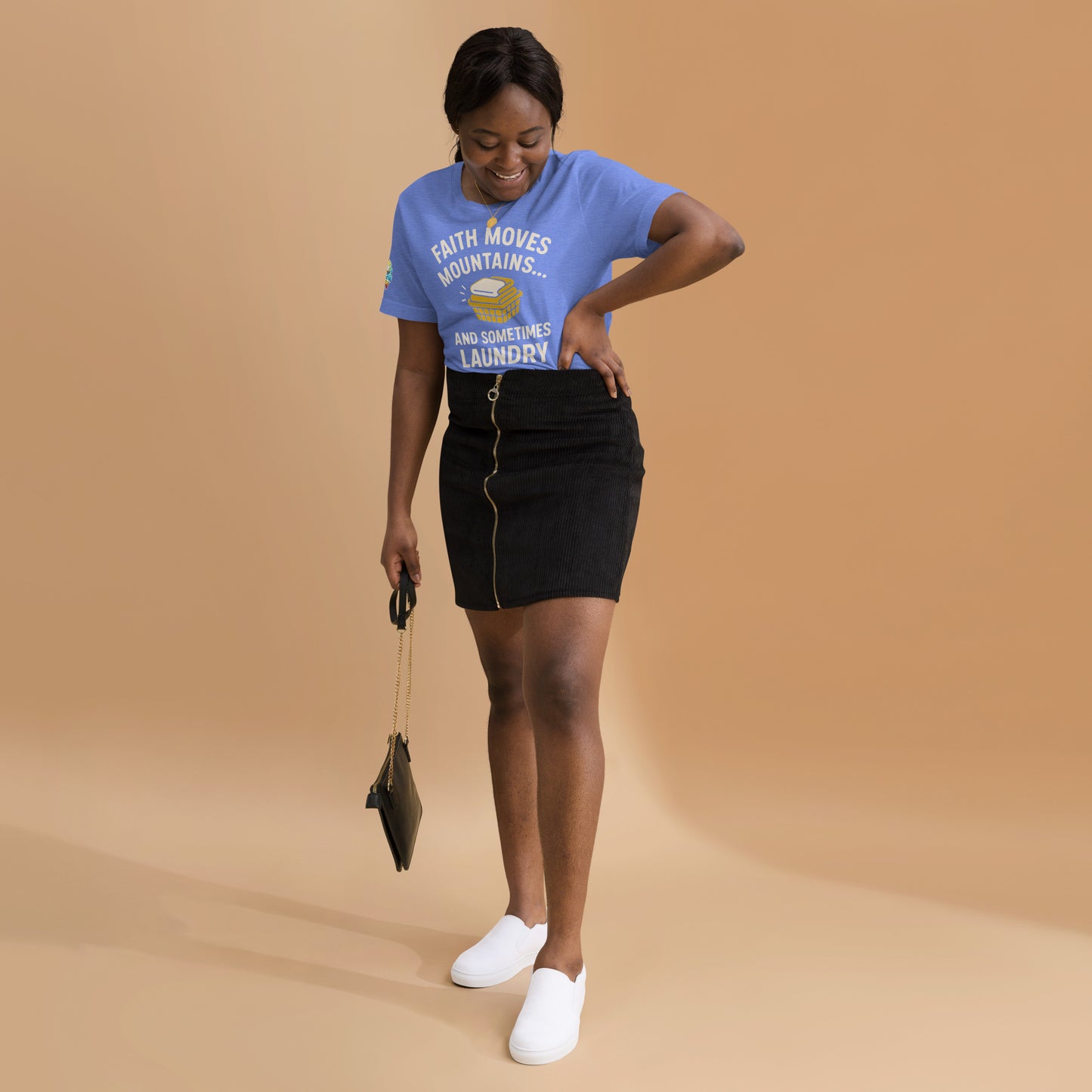 Model showcasing a Faith Moves Mountains… and Sometimes Laundry – funny Christian t-shirt, heather columbia blue, faith-based humor design by ReBirth Living