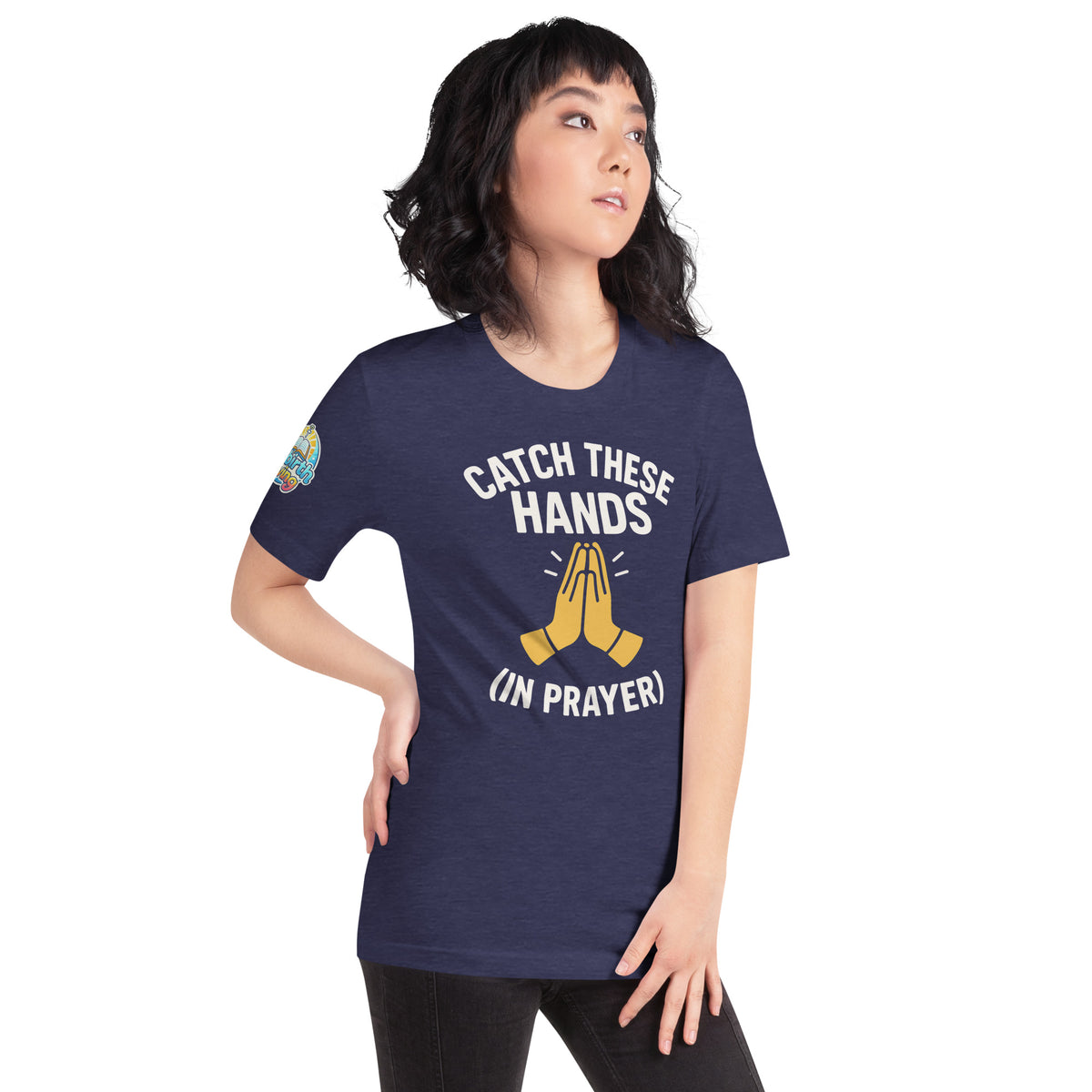 Model wearing “Catch These Hands (In Prayer)” – funny Christian t-shirt, heather midnight navy, faith-based humor design with golden praying hands by ReBirth Living