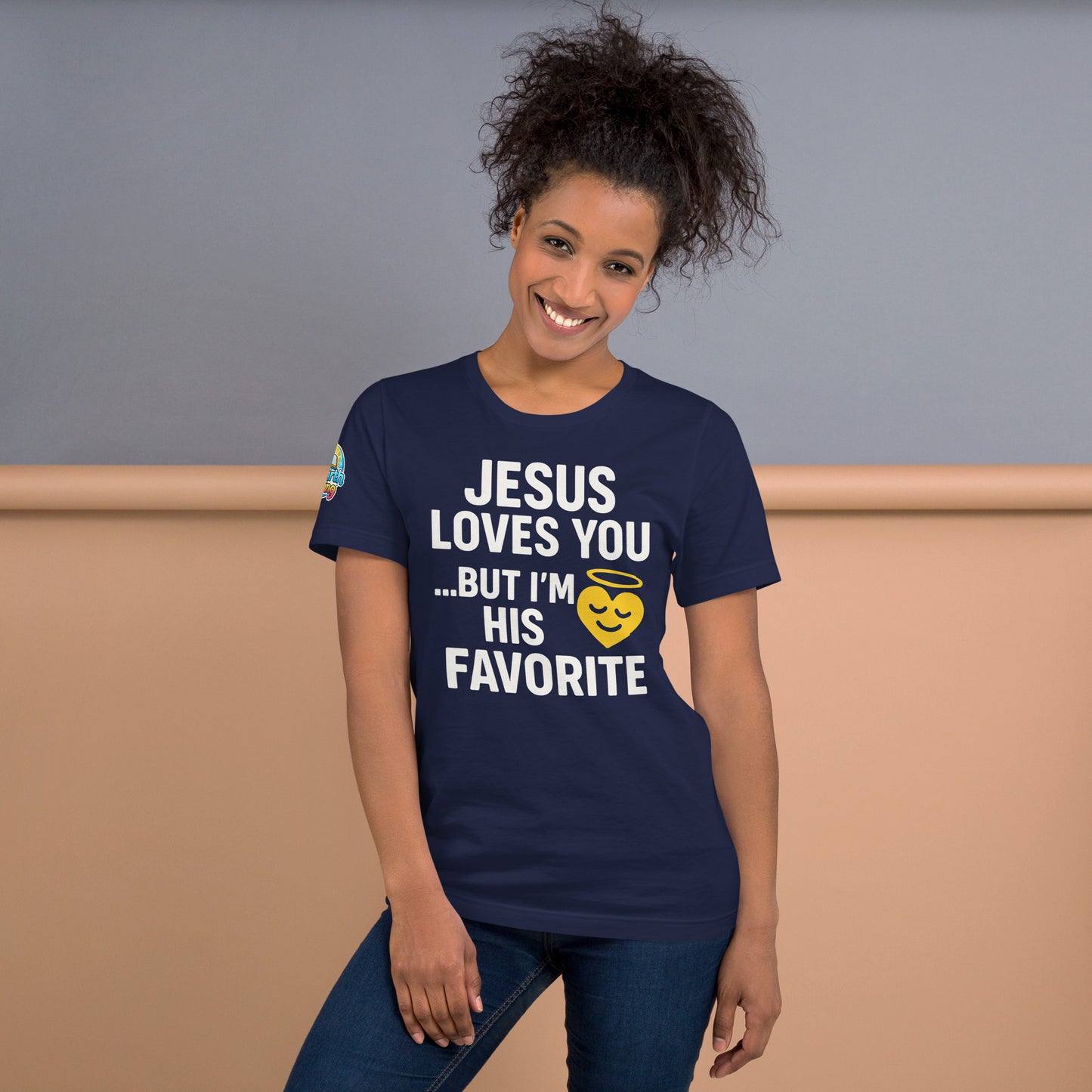 Model wearing “Jesus Loves You… But I’m His Favorite” – funny Christian t-shirt, navy, faith humor design with golden smiling heart and halo by ReBirth Living