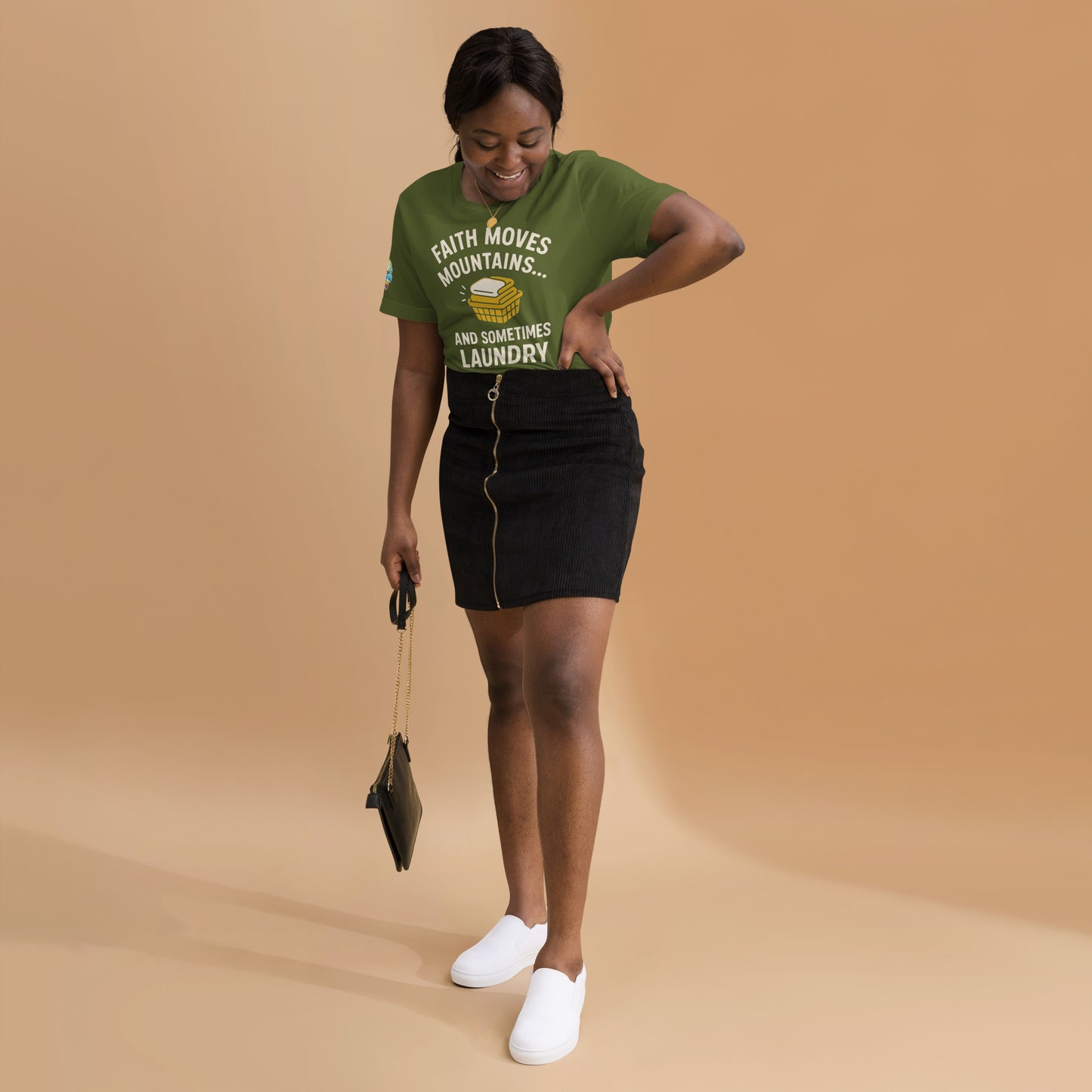 Model showcasing a Faith Moves Mountains… and Sometimes Laundry – funny Christian t-shirt, olive, faith-based humor design by ReBirth Living