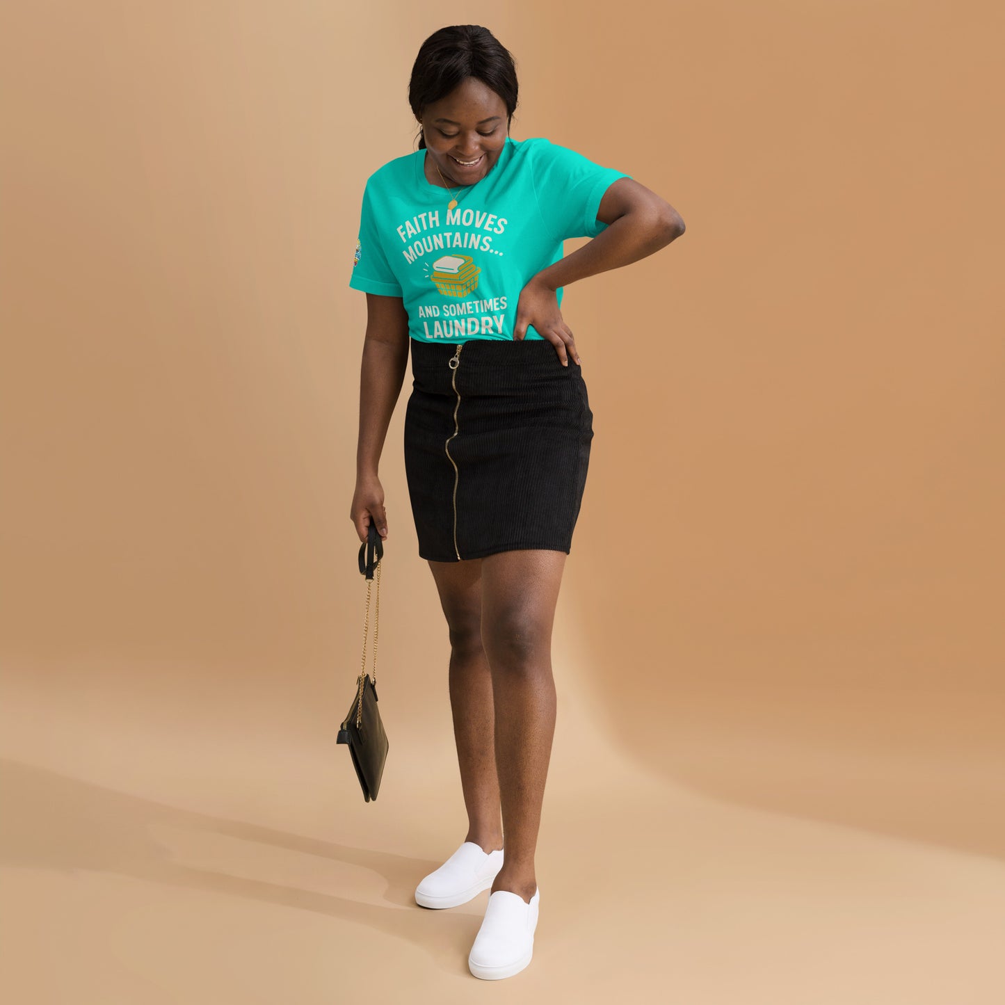 Model showcasing a Faith Moves Mountains… and Sometimes Laundry – funny Christian t-shirt, teal, faith-based humor design by ReBirth Living