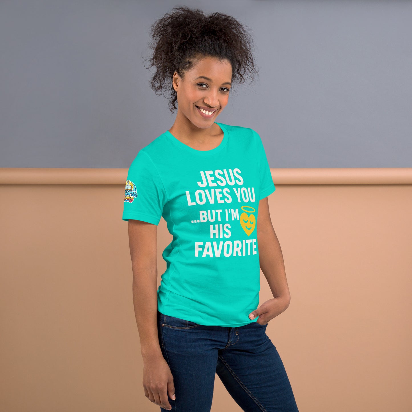 Model wearing “Jesus Loves You… But I’m His Favorite” – funny Christian t-shirt, teal, faith humor design with golden smiling heart and halo by ReBirth Living