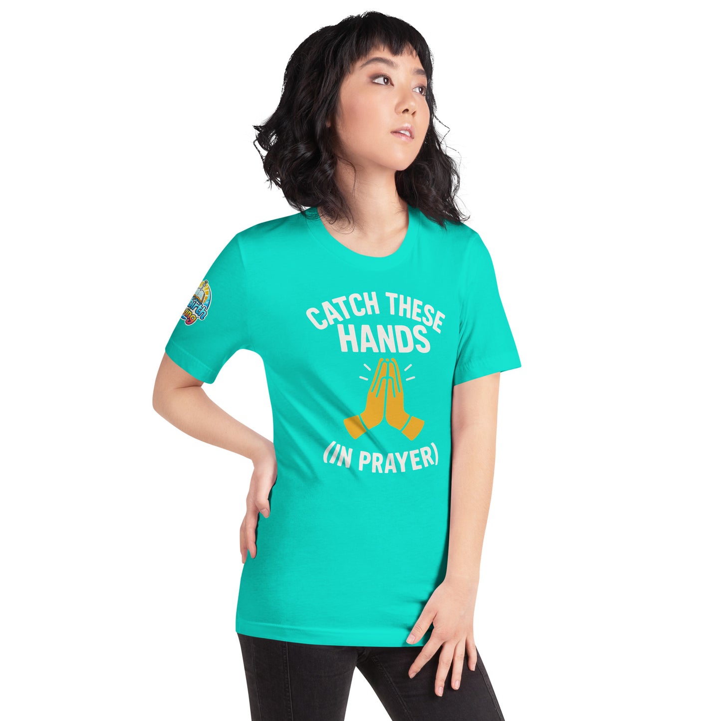 Model wearing “Catch These Hands (In Prayer)” – funny Christian t-shirt, teal, faith-based humor design with golden praying hands by ReBirth Living