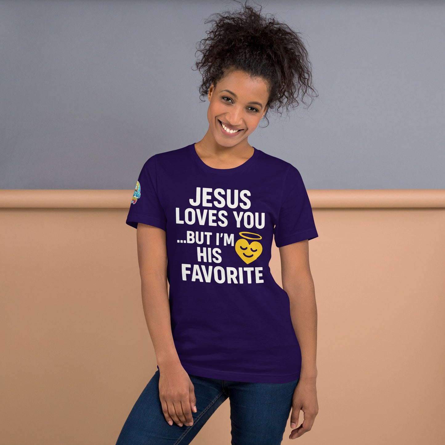 Model wearing “Jesus Loves You… But I’m His Favorite” – funny Christian t-shirt, team purple, faith humor design with golden smiling heart and halo by ReBirth Living