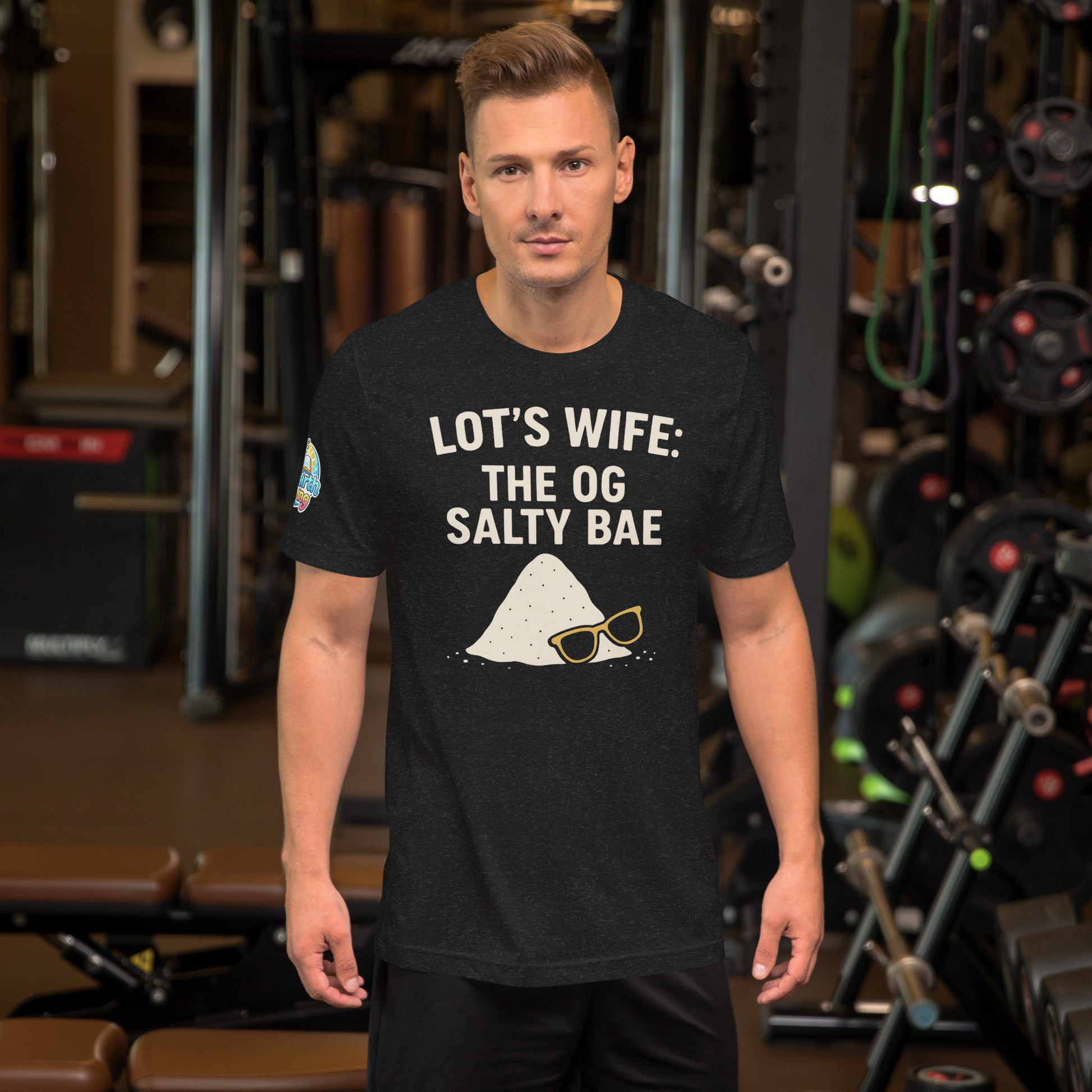 Model wearing a The OG Salty Bae – funny Christian t-shirt, black heather, Bible humor design by ReBirth Living in a gym setting.