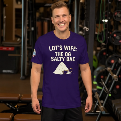 Man wearing a purple t-shirt with text and graphics in a gym setting.  Lot’s Wife: The OG Salty Bae – funny Christian t-shirt, purple, Bible humor design by ReBirth Living