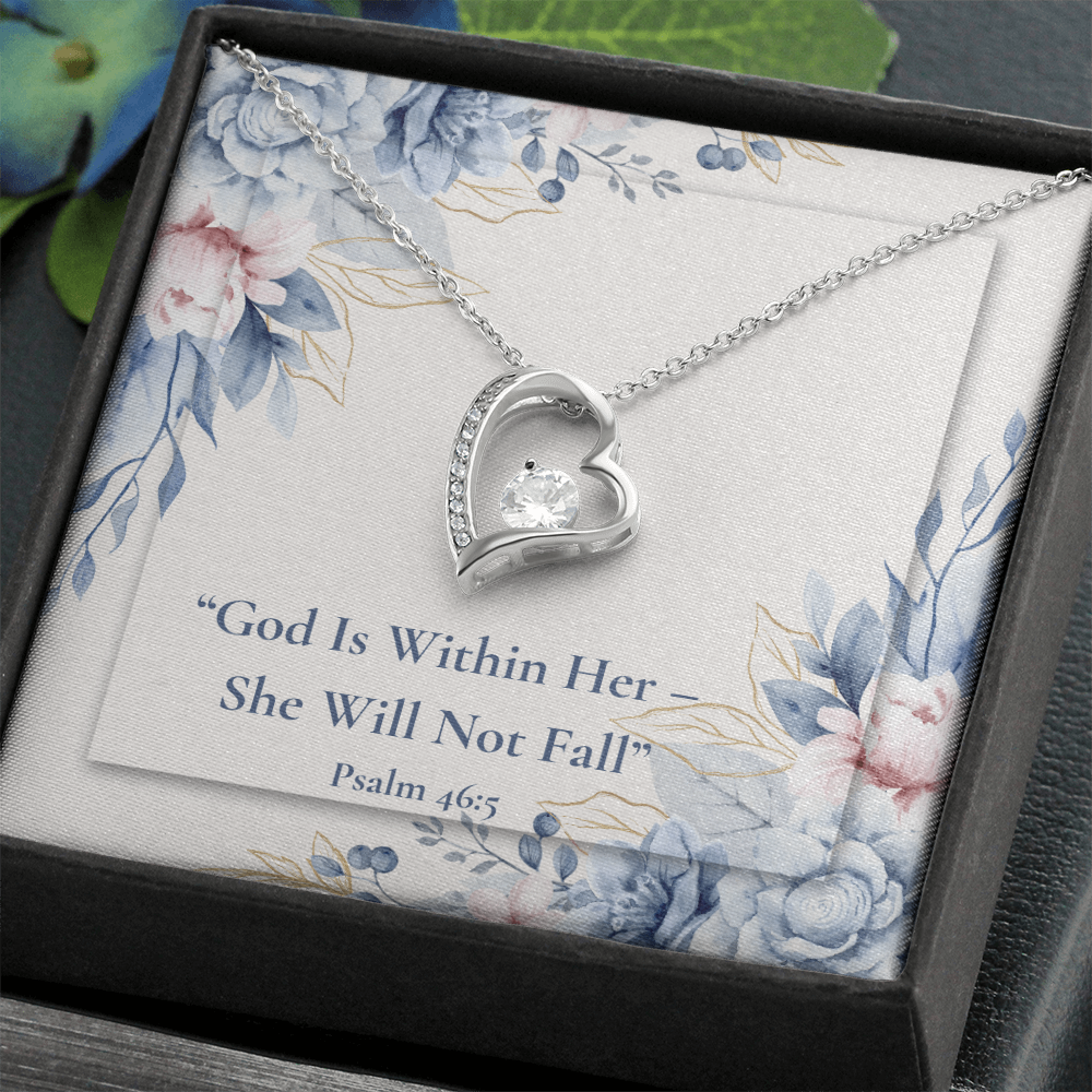 A God Is Within Her – She Will Not Fall forever love necklace – Psalm 46:5 KJV Christian jewelry gift for women by ReBirth Living. In a black jewelry box with a floral design holding the heart shaped necklace with text underneath the necklace.