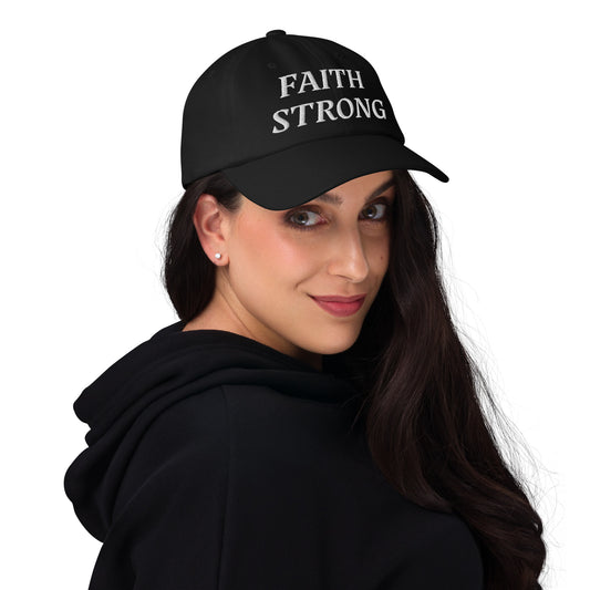 Faith Strong hat – classic white embroidery, adjustable unisex cap available in multiple colors by ReBirth Living. The model has on the black hat with white embroidery.