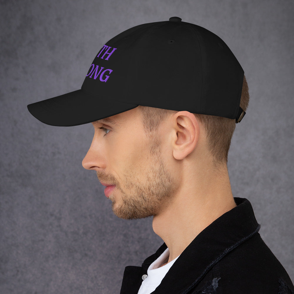 Model is wearing a Faith Strong embroidered hat – bold purple text, black adjustable unisex cap by ReBirth Living