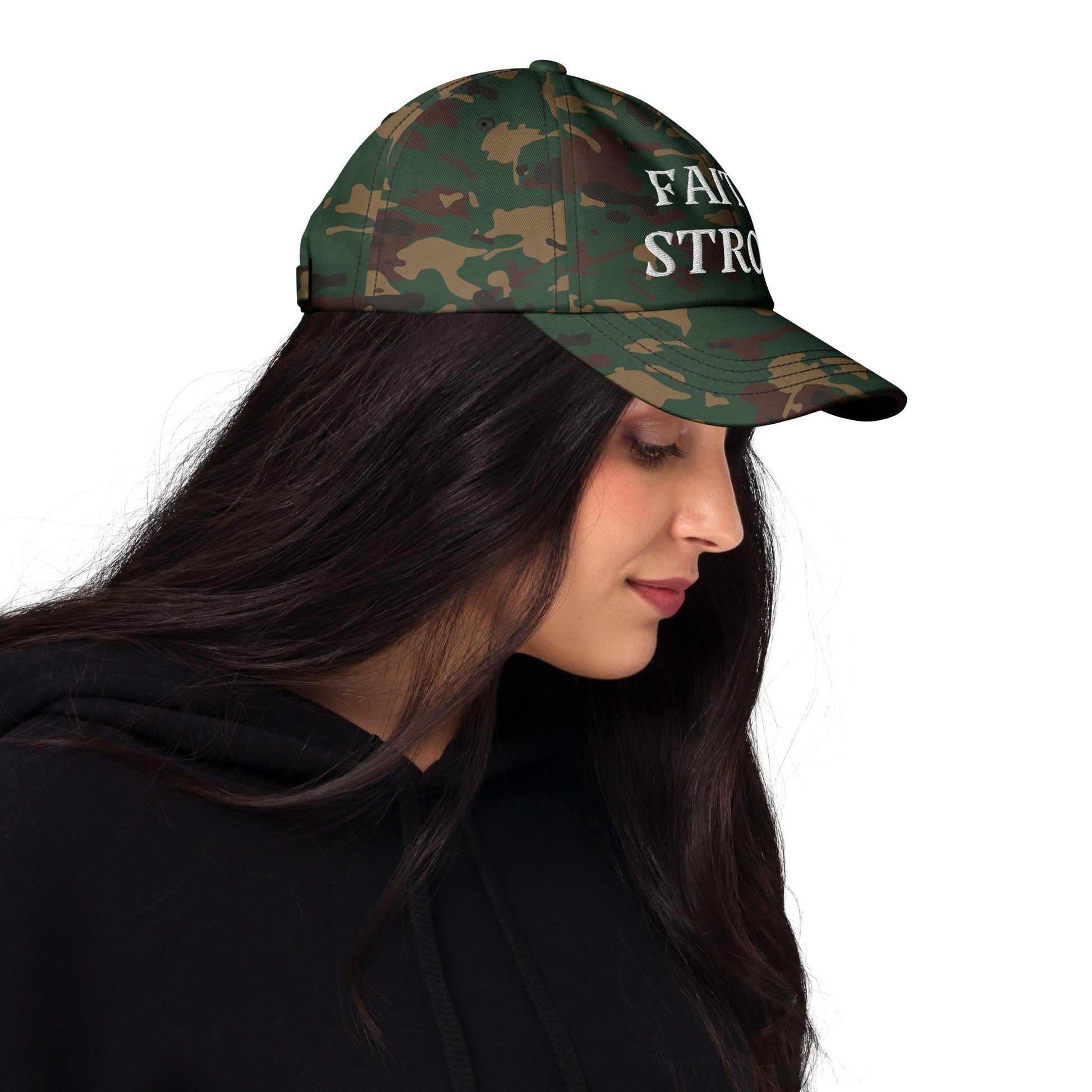 Faith Strong hat – classic white embroidery, adjustable unisex cap available in multiple colors by ReBirth Living. The model has on the green camo hat with white embroidery.