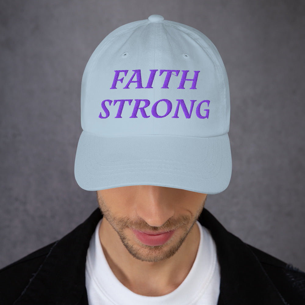 Model is wearing a Faith Strong embroidered hat – bold purple text, light blue adjustable unisex cap by ReBirth Living
