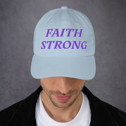 Model is wearing a Faith Strong embroidered hat – bold purple text, light blue adjustable unisex cap by ReBirth Living