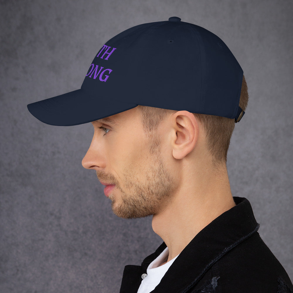 Model is wearing a Faith Strong embroidered hat – bold purple text, navy adjustable unisex cap by ReBirth Living