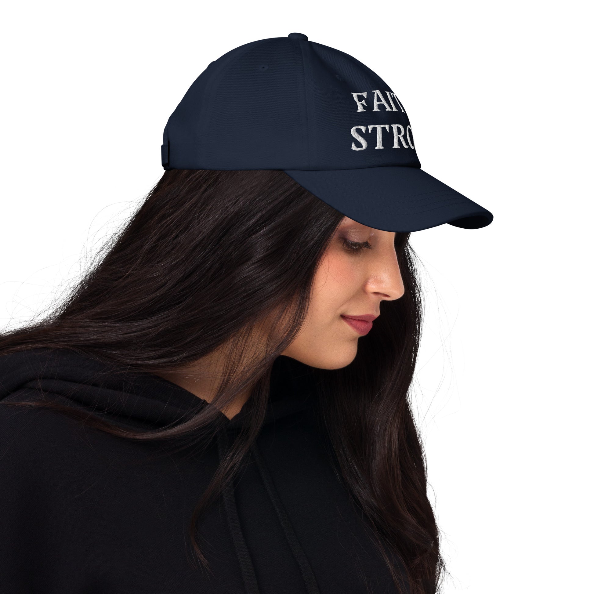 Faith Strong hat – classic white embroidery, adjustable unisex cap available in multiple colors by ReBirth Living. The model has on the navy hat with white embroidery.