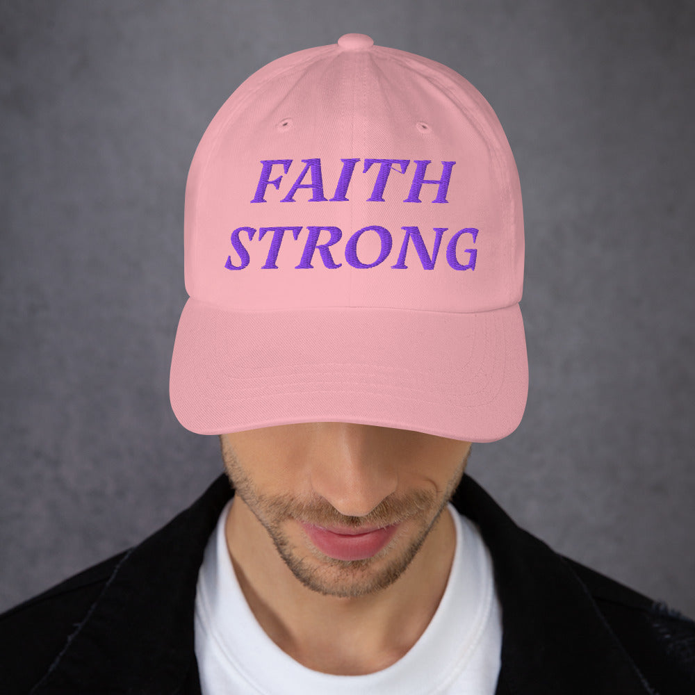 Model is wearing a Faith Strong embroidered hat – bold purple text, pink adjustable unisex cap by ReBirth Living