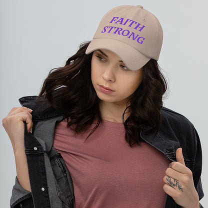 Person is wearing a Faith Strong stone cap – bold Christian statement hat with purple embroidery, adjustable unisex design by ReBirth Living