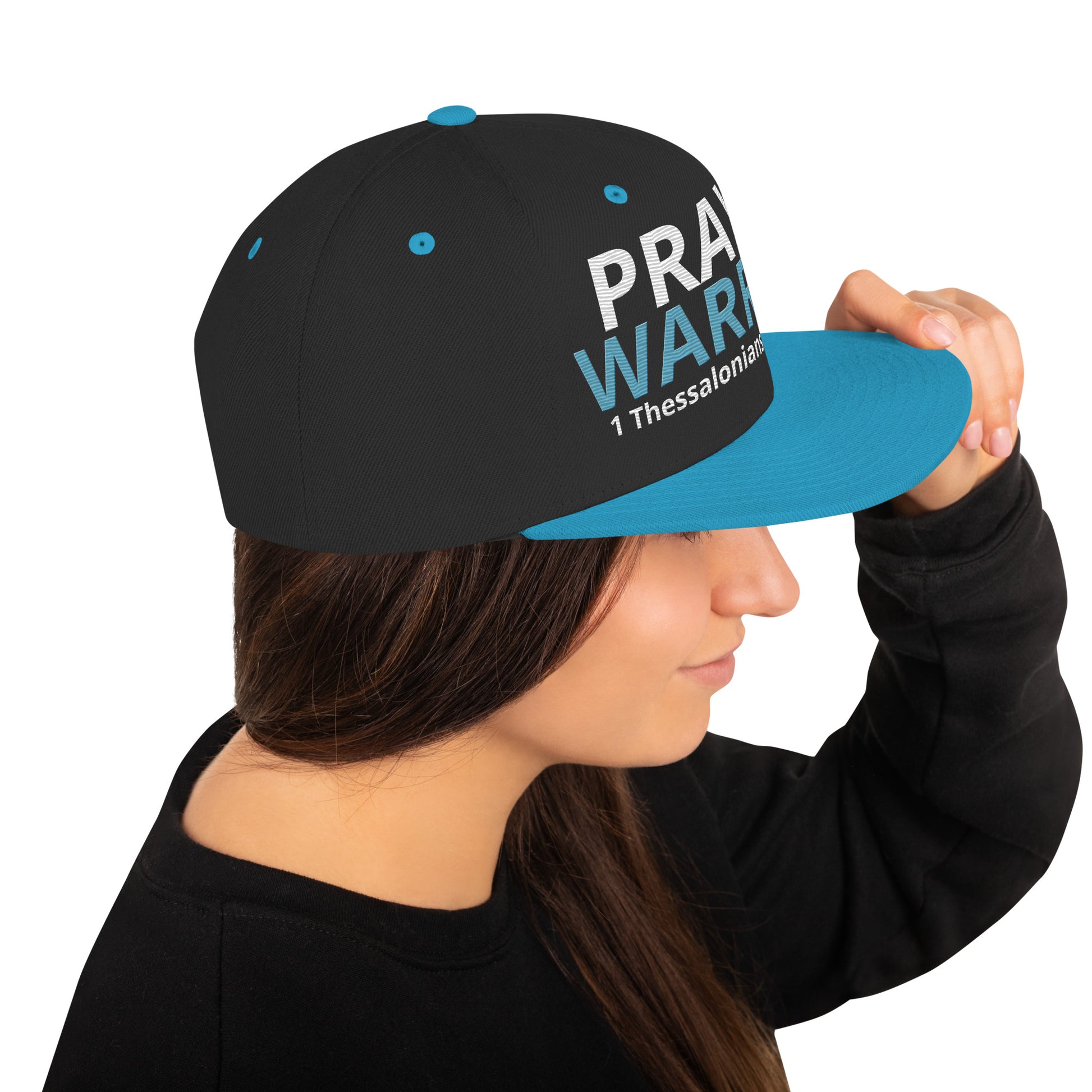 A person is wearing a Prayer Warrior snapback hat – 1 Thessalonians 5:16-17 KJV embroidered Christian cap, adjustable unisex design by ReBirth Living. 