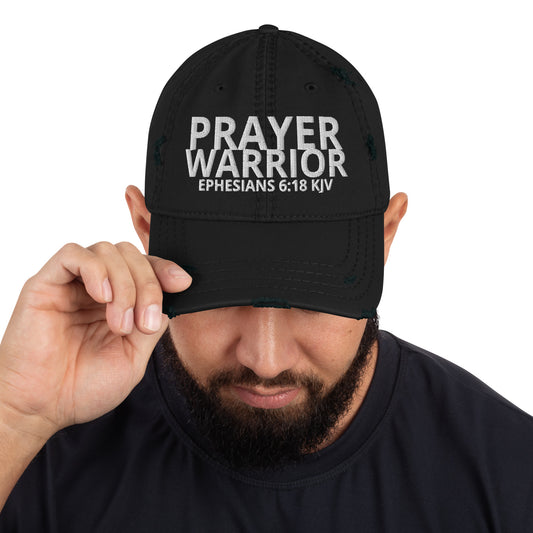 A person is wearing a Prayer Warrior Christian hat – distressed cap with Ephesians 6:18 KJV embroidered Bible verse, black, adjustable unisex faith-based headwear by ReBirth Living