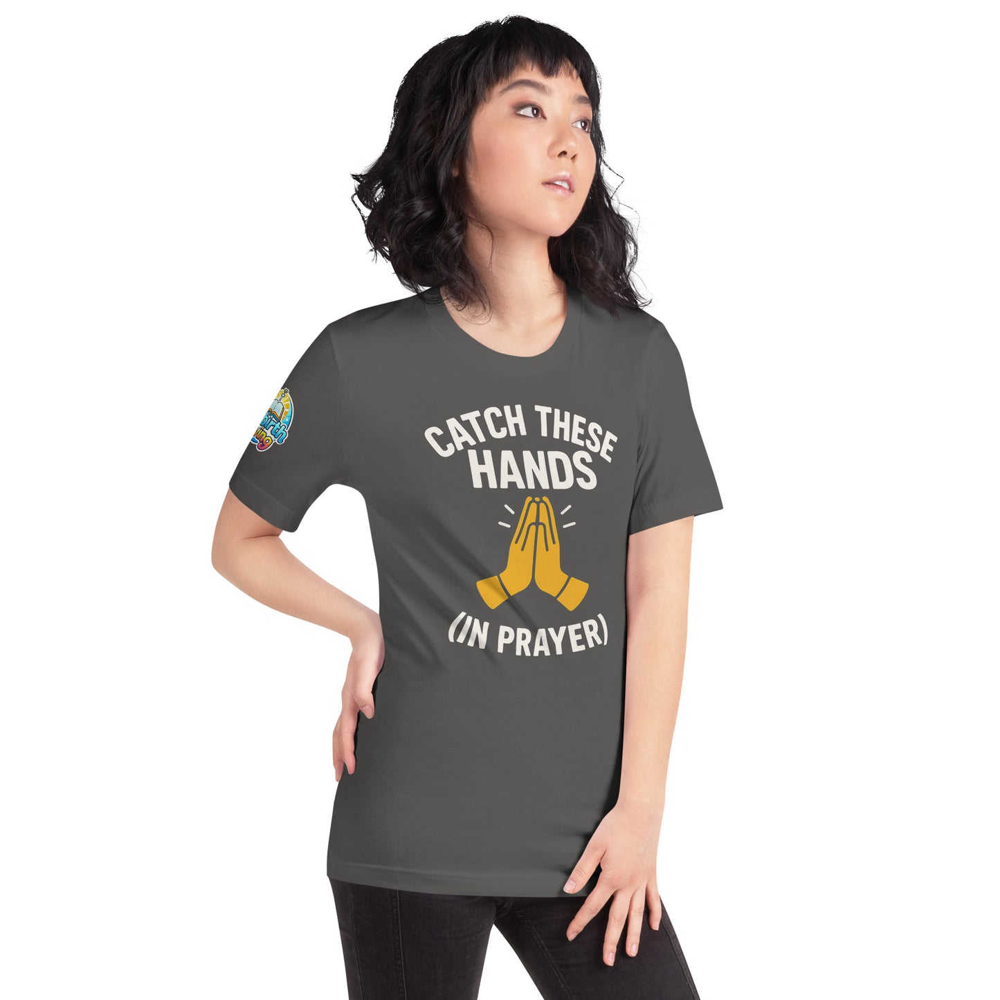 Model wearing “Catch These Hands (In Prayer)” – funny Christian t-shirt, asphalt, faith-based humor design with golden praying hands by ReBirth Living
