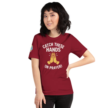Model wearing “Catch These Hands (In Prayer)” – funny Christian t-shirt, cardinal, faith-based humor design with golden praying hands by ReBirth Living