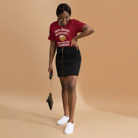 Woman wearing a cardinal t-shirt with text and a black skirt on a beige background. Faith Moves Mountains… and Sometimes Laundry – funny Christian t-shirt, cardinal, faith-based humor design by ReBirth Living