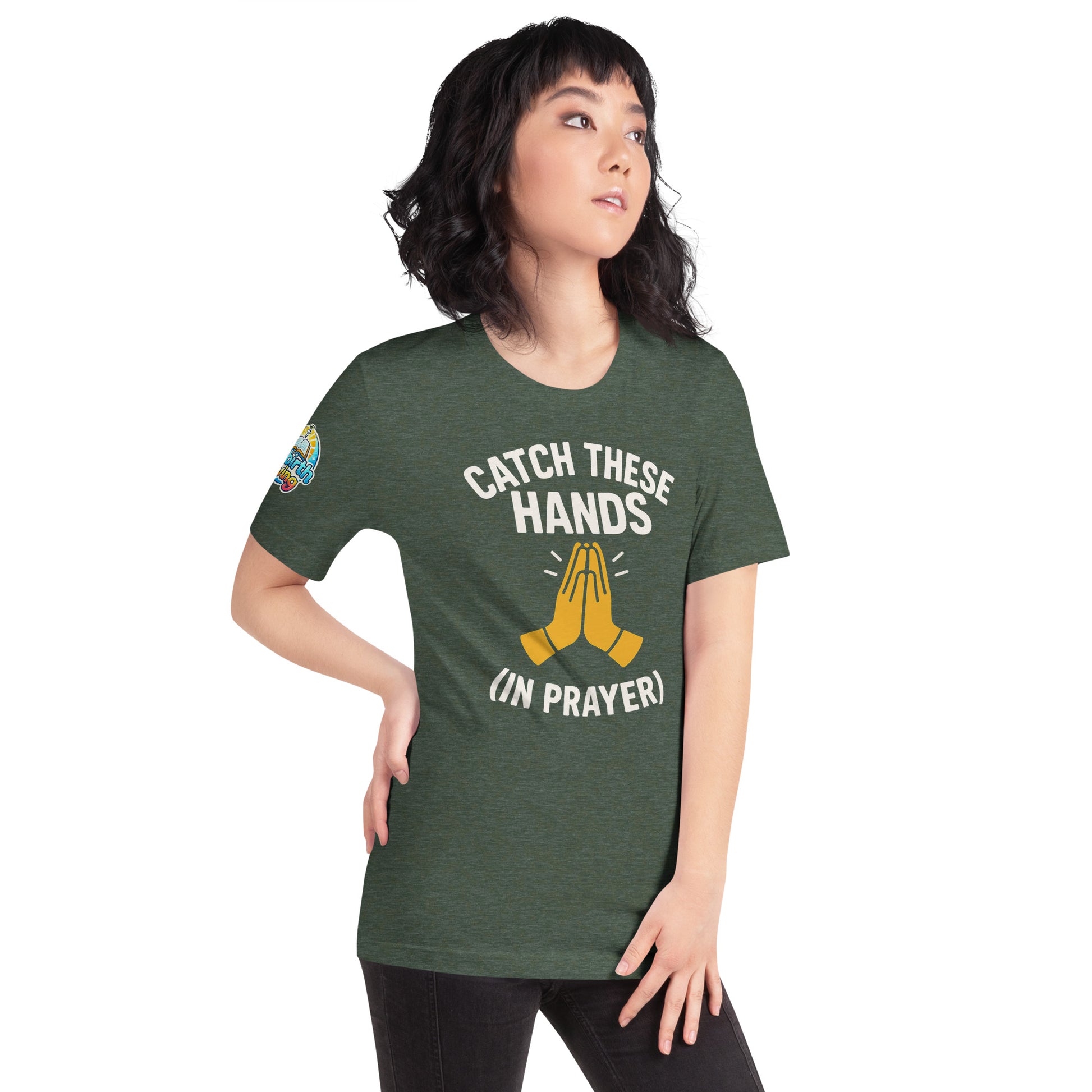 Model wearing “Catch These Hands (In Prayer)” – funny Christian t-shirt, heather forest green, faith-based humor design with golden praying hands by ReBirth Living