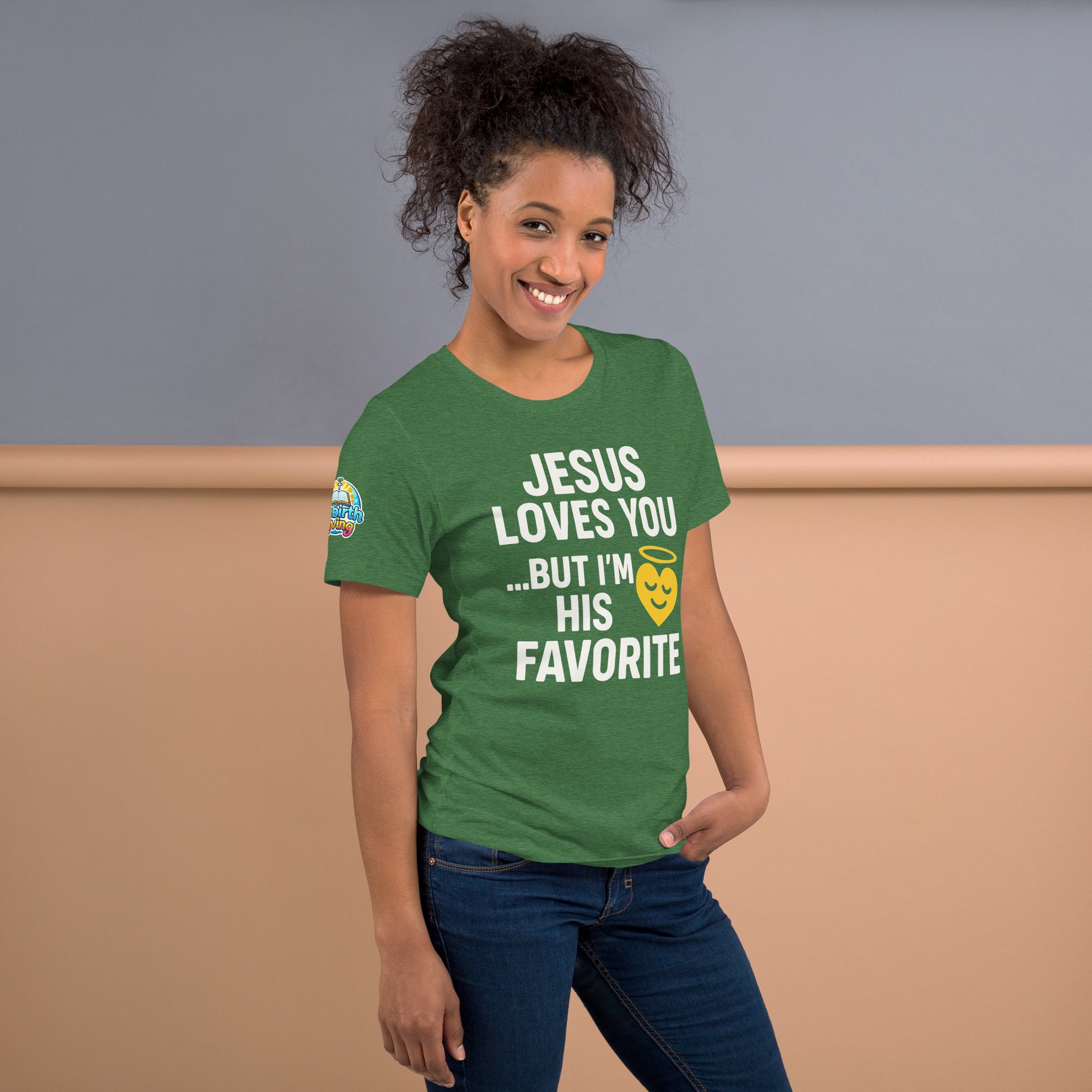 Model wearing “Jesus Loves You… But I’m His Favorite” – funny Christian t-shirt, heather grass green, faith humor design with golden smiling heart and halo by ReBirth Living