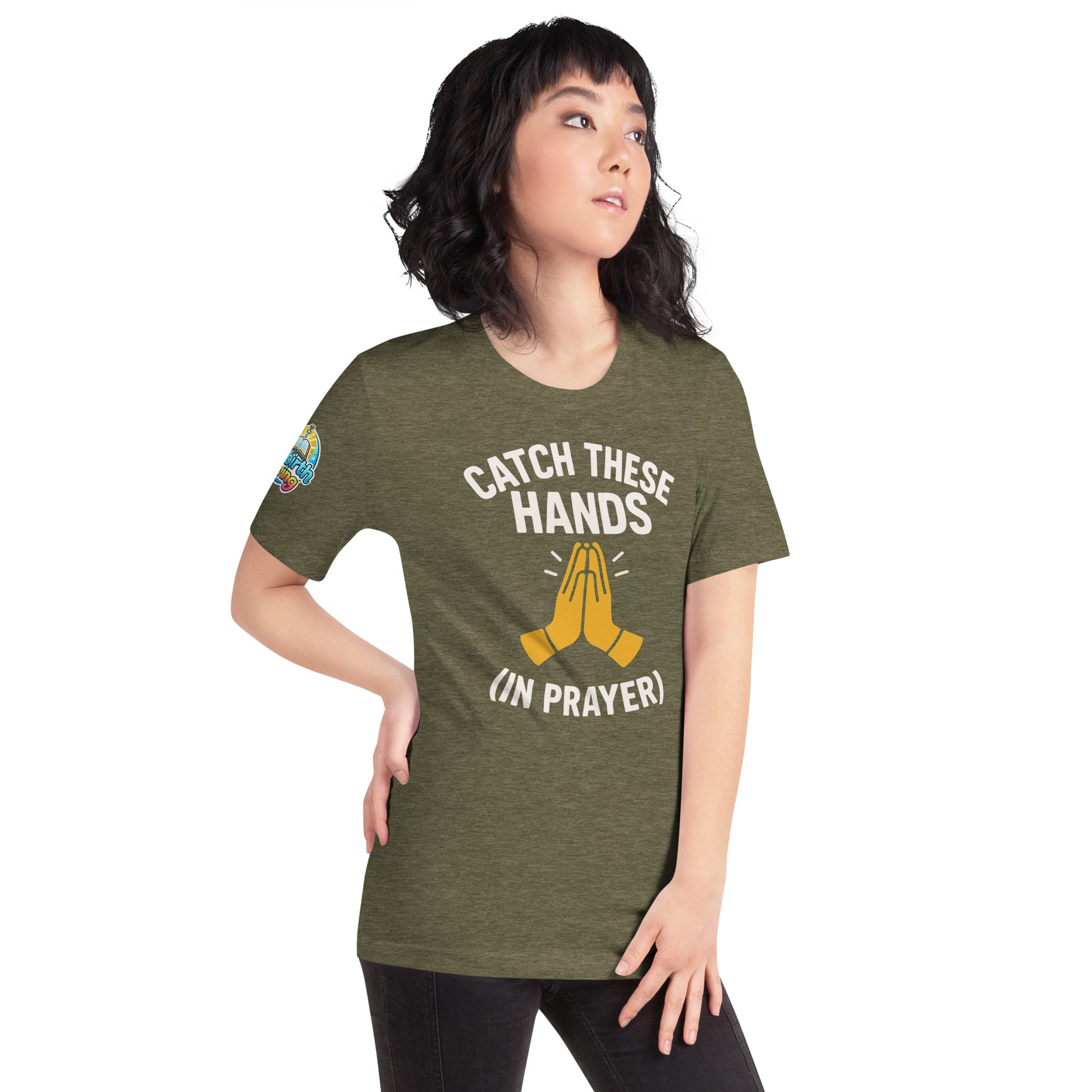 Model wearing “Catch These Hands (In Prayer)” – funny Christian t-shirt, heather olive green, faith-based humor design with golden praying hands by ReBirth Living