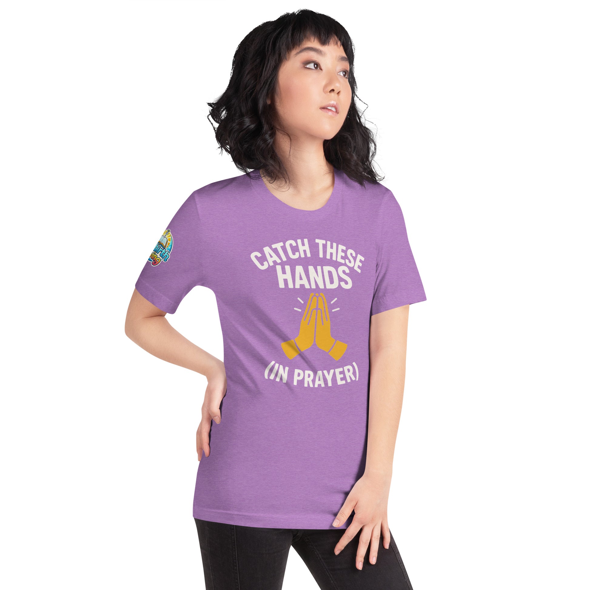 Model wearing “Catch These Hands (In Prayer)” – funny Christian t-shirt, heather team purple, faith-based humor design with golden praying hands by ReBirth Living