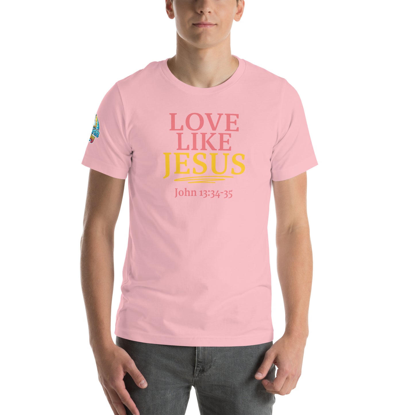 A person is wearing a Love Like Jesus Christian t-shirt – bold faith graphic tee for men and women, pink, unisex design by ReBirth Living