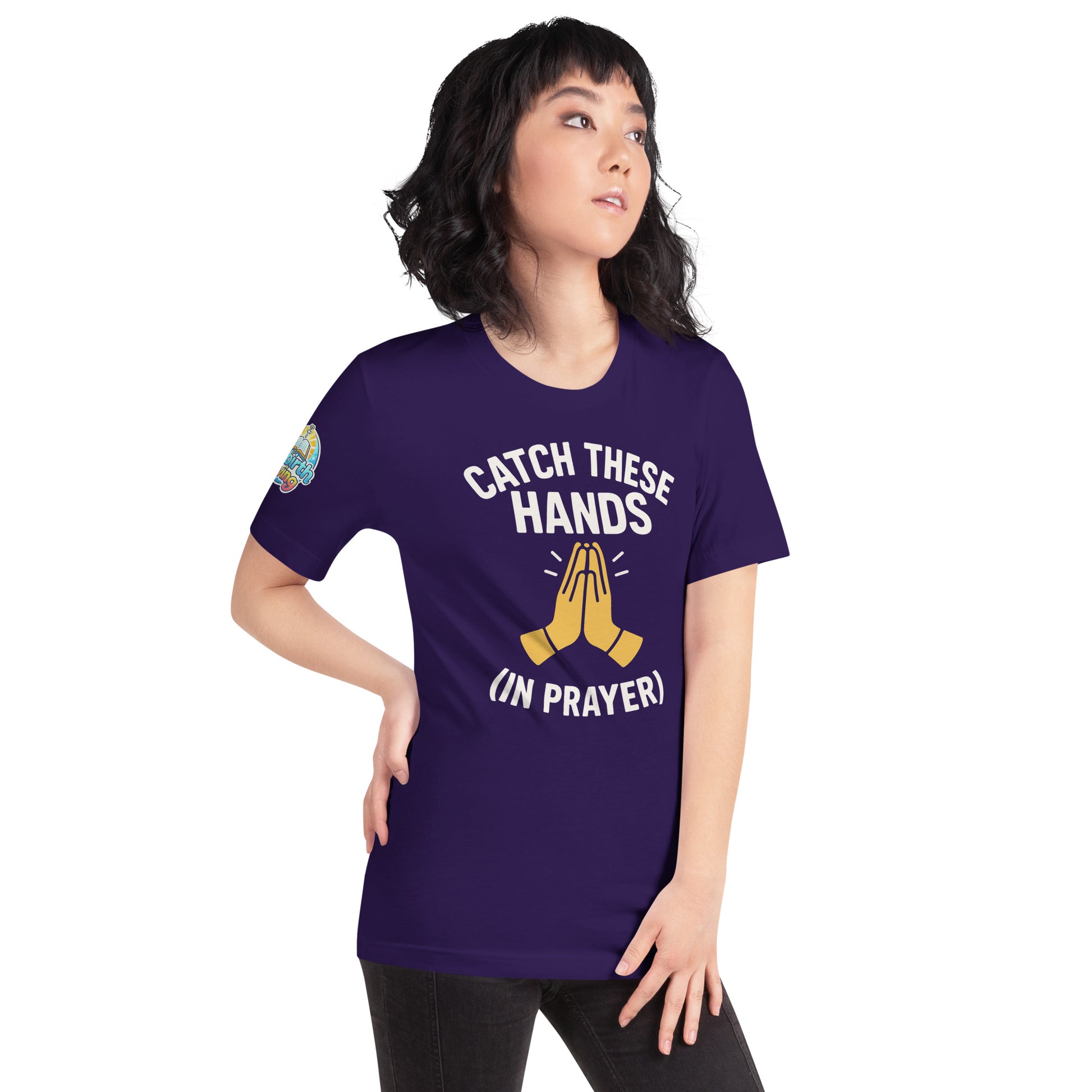 Model wearing “Catch These Hands (In Prayer)” – funny Christian t-shirt, team purple, faith-based humor design with golden praying hands by ReBirth Living