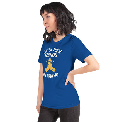 Model wearing “Catch These Hands (In Prayer)” – funny Christian t-shirt, true royal, faith-based humor design with golden praying hands by ReBirth Living